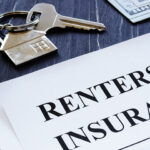 Renters Insurance policy agreement and key from apartments.